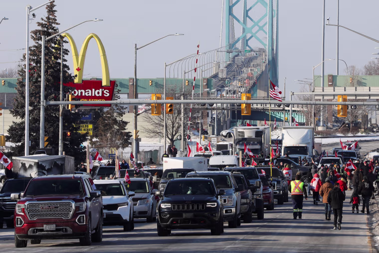 Image: Vehicles block the route leading from the Ambassador Bridge, linking Detroit and Windsor, as truckers and their supporters continue to protest vaccine mandates, in Windsor, Ontario, Canada, on Feb. 8, 2022.