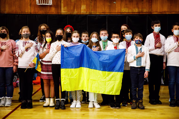 Students sing the Ukrainian national anthem during an assembly about the crisis in Ukraine at Self-Reliance School of Ukrainian Studies in New York on Feb. 26, 2022.