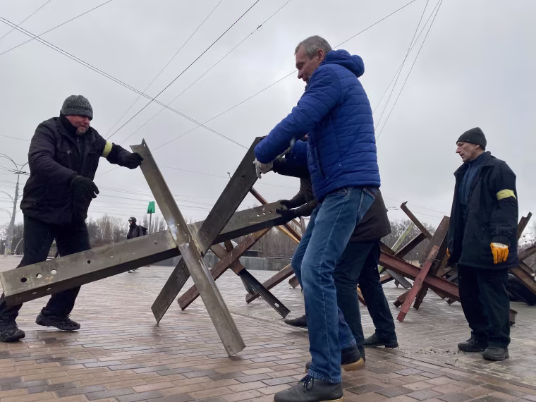 Men move large metal jacks Wednesday into place near the TV tower and an adjacent park where the Babyn Yar Holocaust Memorial Center is located.