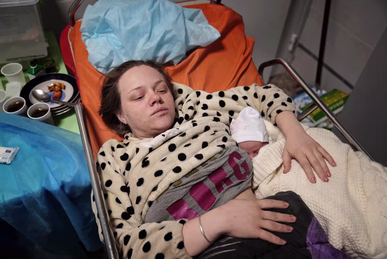Mariana Vishegirskaya lies in a hospital bed after she gave birth to a daughter, Veronika, in Mariupol.