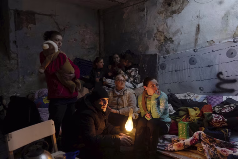 People gather in a bomb shelter. 