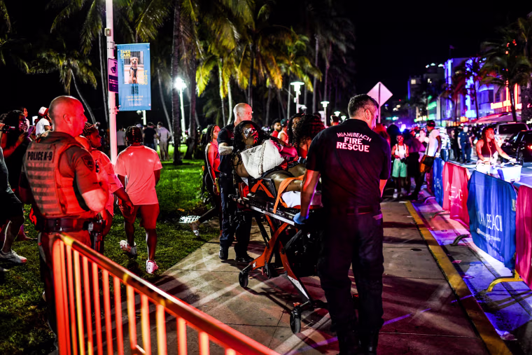 Miami Beach Fire Rescue transport a woman on a stretcher on Ocean Drive in Miami Beach, Fla., on March 17, 2022.