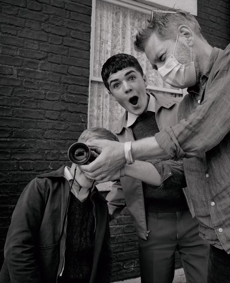 Actor Jude Hill, actor Lewis McAskie and writer/director Kenneth Branagh on the set of "Belfast."