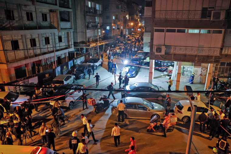 Image: Israeli security forces and emergency personnel gather at the scene of a shooting attack on March 29, 2022 in Bnei Brak.