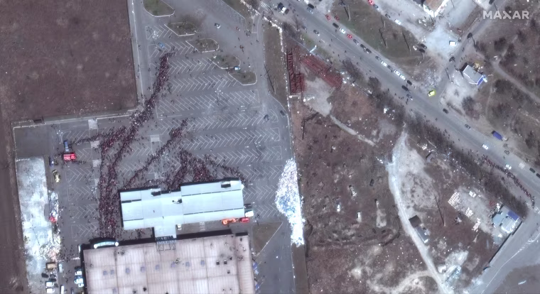 Image: A satellite image shows a closer view of crowds outside a Metro grocery store, in Mariupol