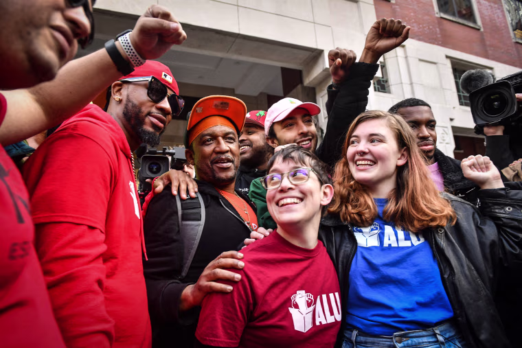 Image: Union organizer Christian Smalls, left, celebrates following the April 1, 2022, vote for the unionization of the Amazon Staten Island warehouse in New York.