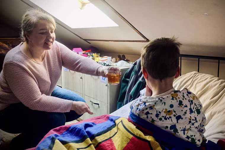 Tetyana Gorshunova spends time with her son in the room they share with three other refugee families in Warsaw on Easter Sunday.