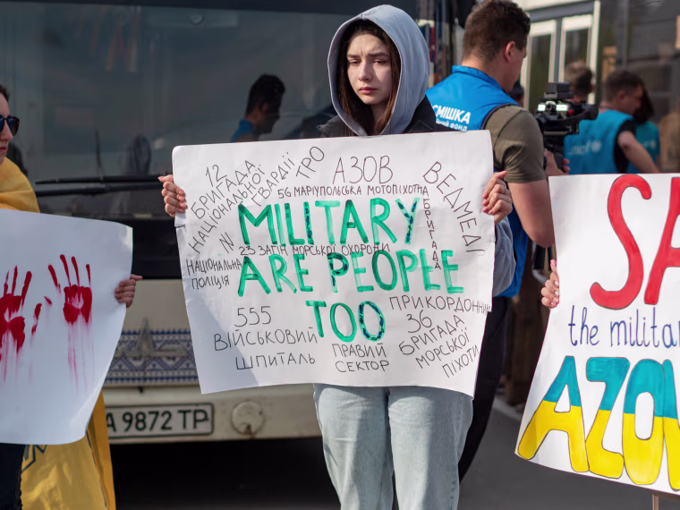 Relatives of Ukrainian service members protest as buses of evacuees arrived in Zaporizhzhia on Tuesday. 
