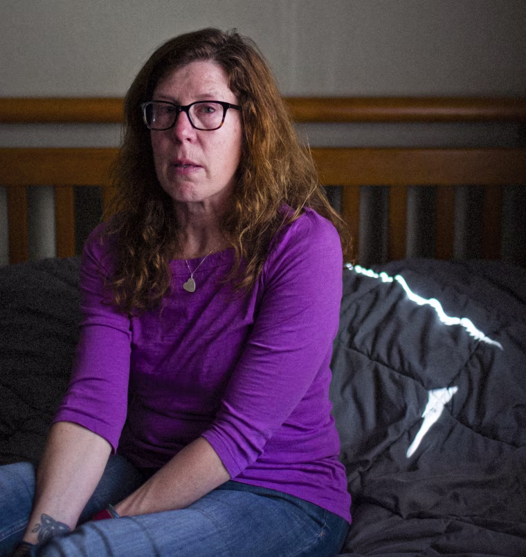 Pauline Stuart sits on her son's bed.