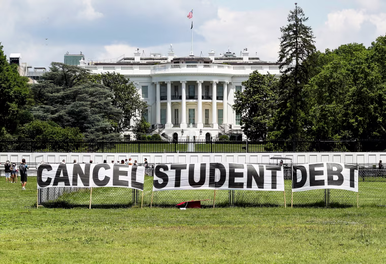 Advocates set up a sign on the Ellipse in front of the White House to call on President Joe Biden to sign an executive order to cancel student debt on June 15, 2021.