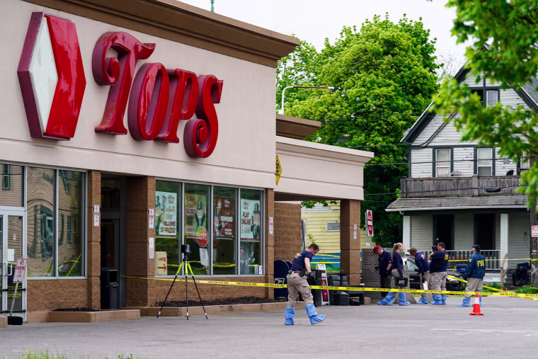 Investigators work at a Tops Friendly Market
