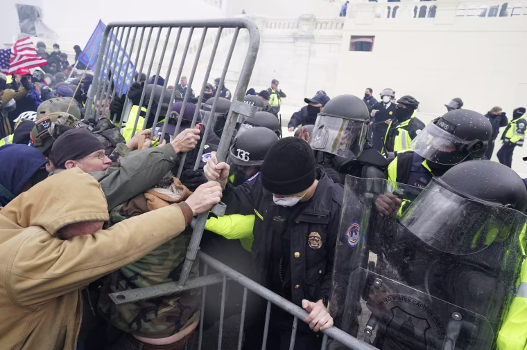Police try to hold back protesters at the Capitol