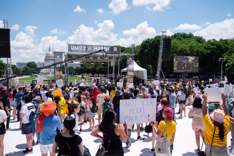 Demonstrators listen to speakers during the Unity March rally