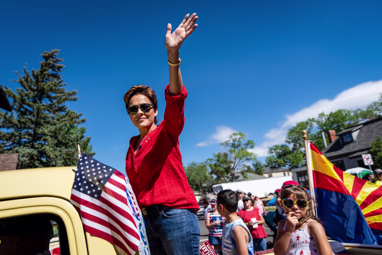 Kari Lake, Republican candidate for Governor of Arizona, waves at the Flagstaff Chamber of Commerce Fourth of July Parade in Flagstaff, Ariz., on July 4, 2022.