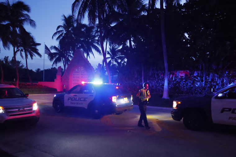 Police direct traffic outside an entrance to former President Donald Trump's Mar-a-Lago estate in Palm Beach, Fla., on Aug. 8, 2022.