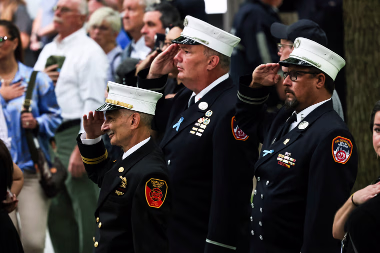 Firefighters salute during the singing of the National Anthem at the annual 9/11 Commemoration Ceremony on Sept. 11, 2022, in New York.