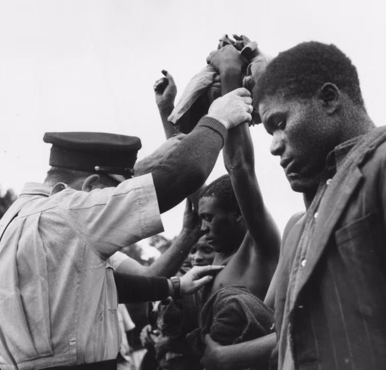 British police examine suspects for the seven initiation cuts on the body that mark a member of the Mau Mau secret society on Nov. 24, 1952.