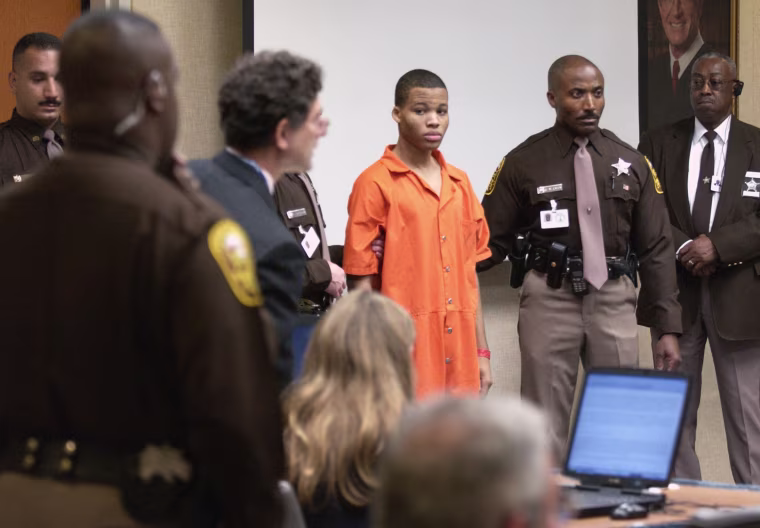 Lee Boyd Malvo, center, is brought into court during the murder trial in 2003.
