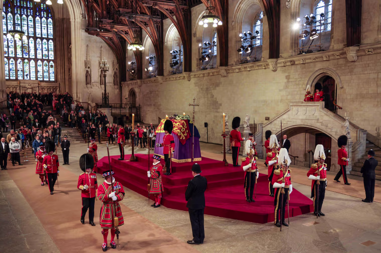 Image: The King's Body Guard, formed of Gentlemen at Arms, Yeomen of the Guard and Scots Guards, change guard duties around the coffin of Queen Elizabeth II, lying in state inside Westminster Hall in London on Sept. 18, 2022.