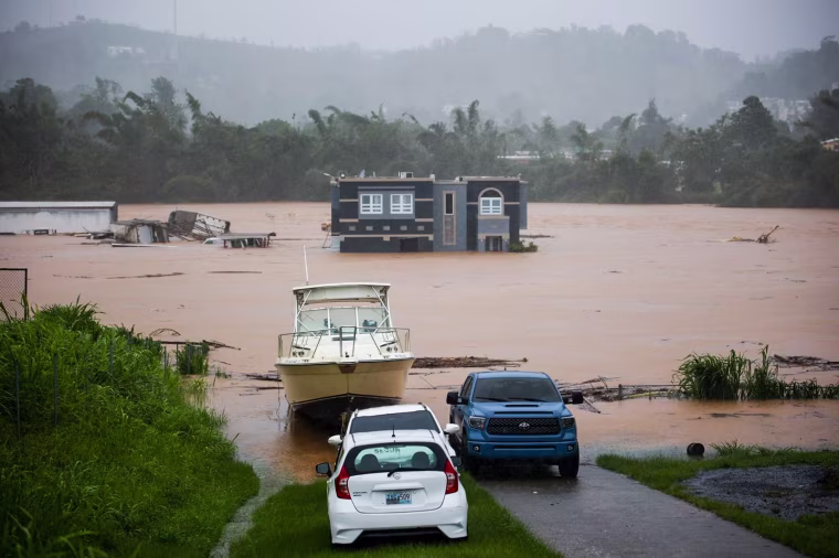 People inside a house await rescue from the floods caused by Hurricane Fiona in Cayey, Puerto Rico, on Sept. 18, 2022.