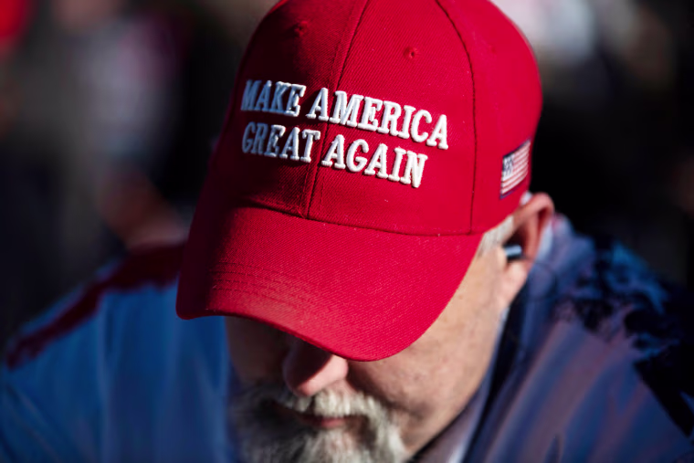 A person wears a MAGA hat