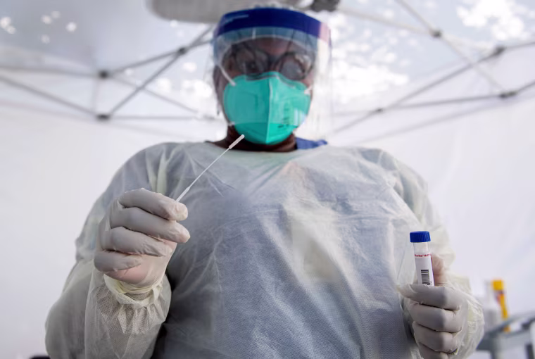 Image: A healthcare worker prepares to take a nasal swab sample at a Covid-19 testing site in Los Angeles in 2020.