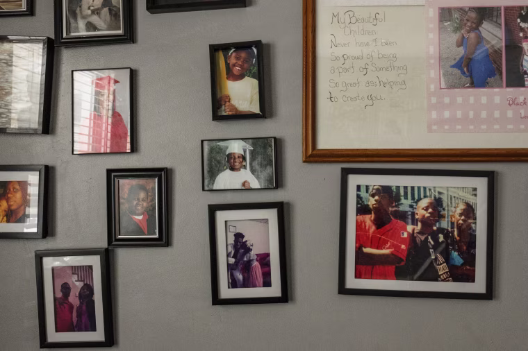 A wall of family photos in April Lee's home.