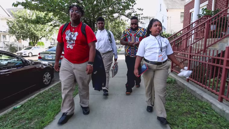 Tai Thergood and his children Taizir, left, Tajh, cetner, and Taraji walking home from school.
