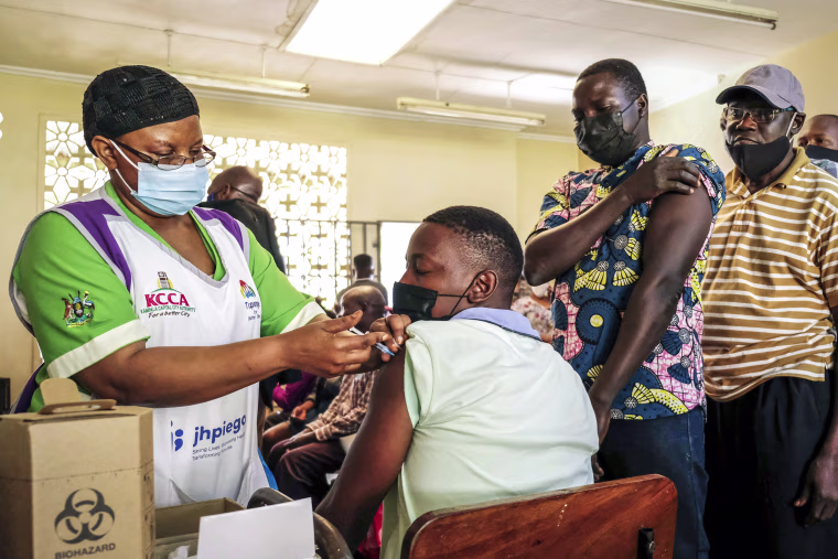Ugandans receive Pfizer coronavirus vaccinations at the Kiswa Health Centre III in the Bugolobi neighborhood of Kampala, Uganda, on Feb. 8, 2022. Ugandan authorities are seeking to legally mandate vaccines to inoculate more people against COVID-19, with a proposed bill calling for a six-month jail term for failure to comply with vaccination requirements, but the draft legislation is subject to changes as it faces scrutiny by a parliamentary health committee.