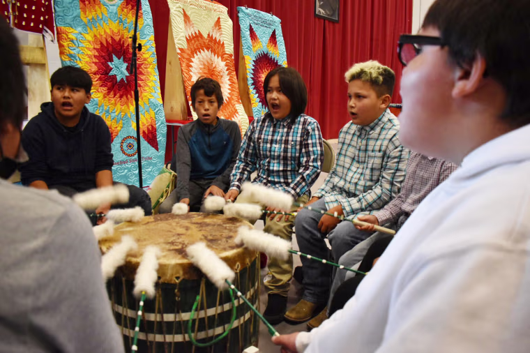Students from Rosebud Elementary School perform in a drum circle 