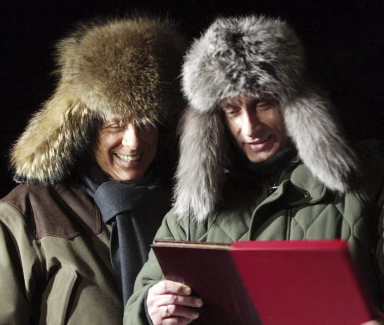 Putin presents a book about his rural lodge to Berlusconi in Zavidovo, northwest of Moscow, in 2003.