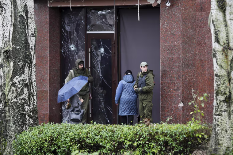 Soldiers guard the entrance of a government building in Donetsk, the capital of the self-proclaimed Donetsk People's Republic in eastern Ukraine on Oct. 20, 2022. 