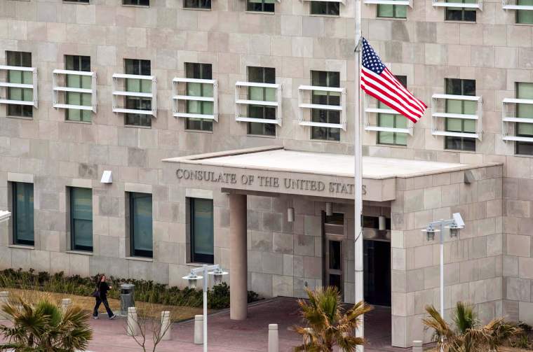 The U.S. national flag at half-mast at the entrance of the consulate of the United States in Ciudad Juarez, Chihuahua state, Mexico on March 15, 2010 after attacks on U.S. consular staff and their families that left three dead.