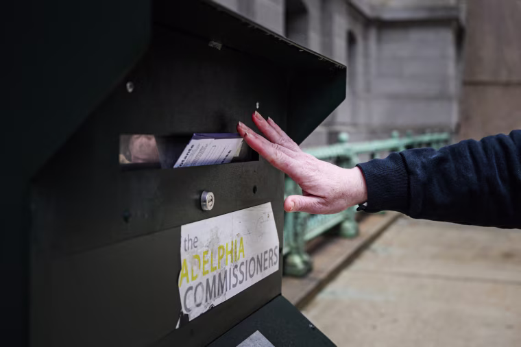 A voter casts their ballot at a drop box at Philadelphia city hall on Oct. 24, 2022. 