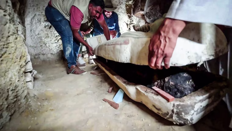 A 3,000-year-old coffin is opened in a burial chamber at the Saqqara in Giza site near Cairo.