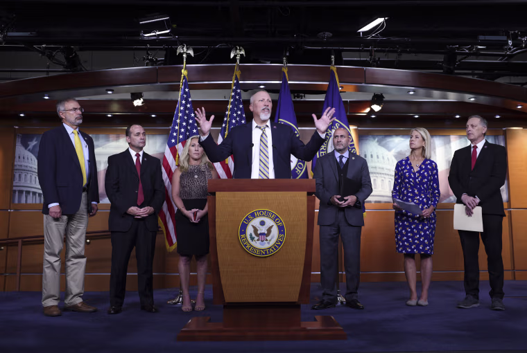 Rep. Chip Roy, joined by fellow Freedom Caucus members, speaks at a news conference