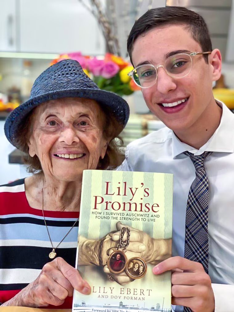Dov Forman and his great-grandmother Lily Ebert holding their book "Lily's Promise."