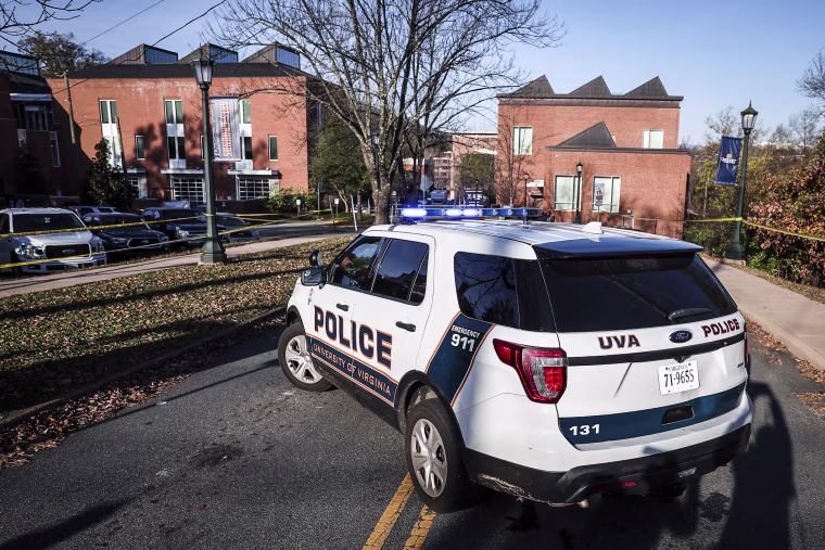 Image: A law enforcement blocks access to the crime scene where 3 people were killed and 2 others wounded on the grounds of the University of Virginia on Nov. 14, 2022 in Charlottesville, Va.