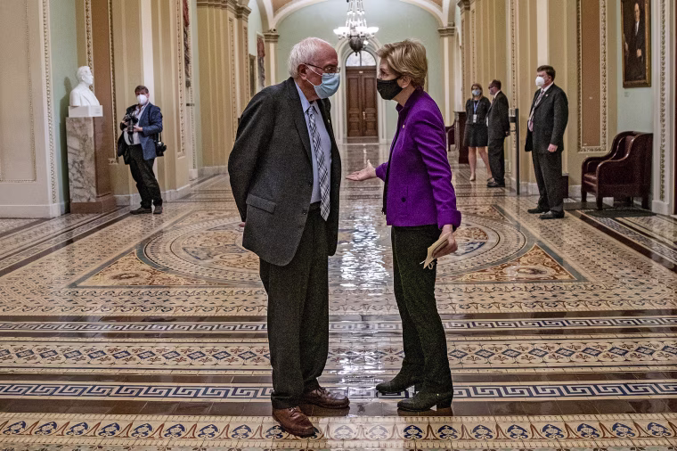 Sen. Bernie Sanders, I-Vt., and Sen. Elizabeth Warren, D-Mass., talk at the Capitol in April 2021.