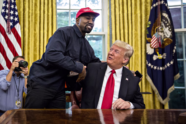 Rapper Kanye West, left, shakes hands with Then-President Donald Trump during a meeting in the Oval Office of the White House on Oct. 11, 2018.