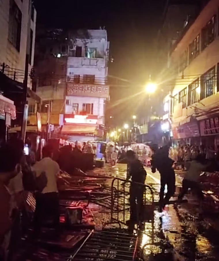 People throw objects at police officers in Guangzhou.
