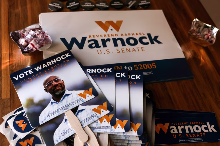 Campaign signs for Georgia Democratic Senate candidate U.S. Sen. Raphael Warnock at a rally in Savannah on Dec. 2, 2022.
