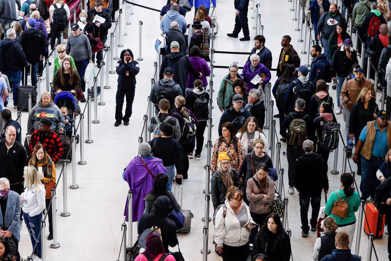 Image: A TSA agent directs passengers on Nov. 21, 2022, in Kenner, La. 