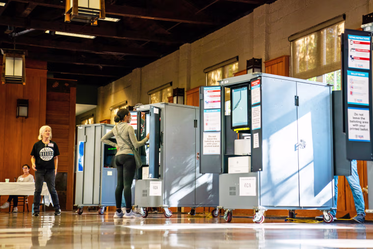 Voters cast their ballot at a polling location