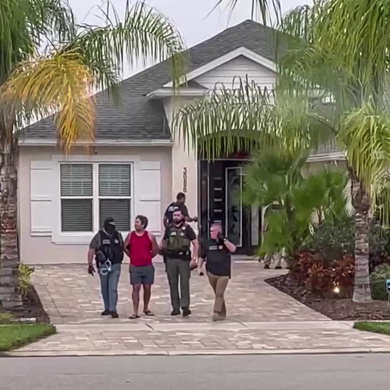 Josh Edwards is taken into custody outside the Edwards family’s New Smyrna Beach home.
