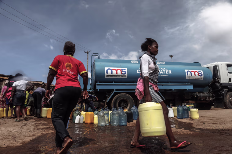 A woman seen carrying her water container filled with water