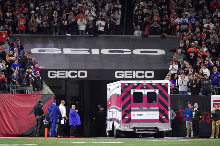Fans look on as the ambulance leaves carrying Damar Hamlin #3 of the Buffalo Bills after he collapsed after making a tackle against the Cincinnati Bengals during the first quarter at Paycor Stadium on January 02, 2023 in Cincinnati, Ohio.
