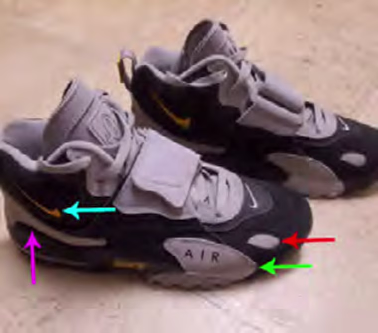 The person wore black and light gray Nike Air Max Speed Turf shoes with a yellow logo.
