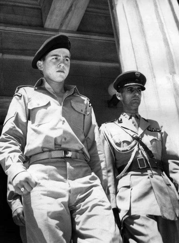 Picture taken on July 5, 1956 showing Crown Prince Constantine (L) as he arrives at the Raiding Forces' Headquarters.