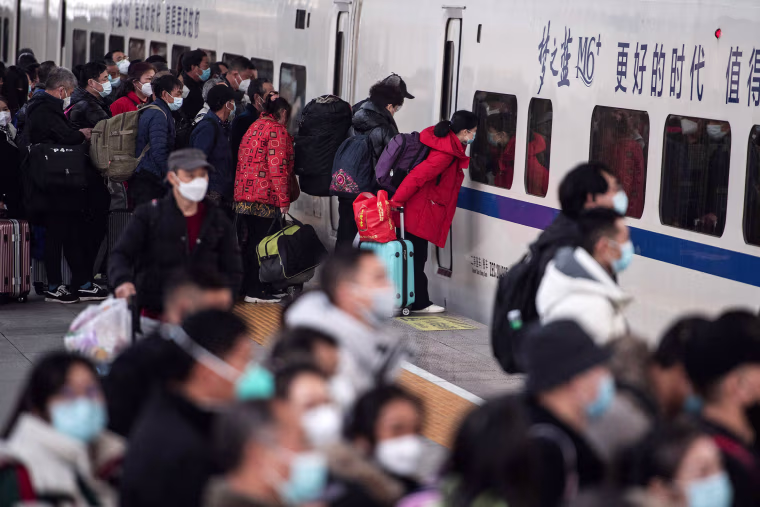 Passengers prepare to board a train at Hankou railway station in central China on Jan. 7, 2023 ahead of the Lunar New Year.